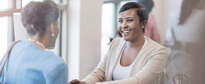 two people talking at a bank