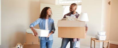 couple holding boxes and moving