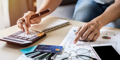 person calculating different kinds of debt