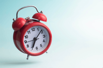 Red alarm clock ring on a blue background warning consumer they have too much debt