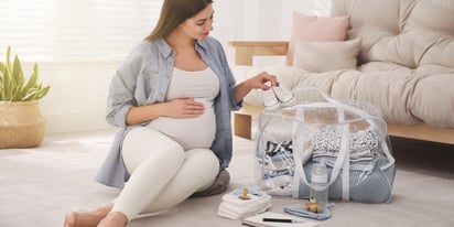 pregnant woman preparing for maternity ward stay at home.