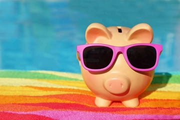 piggy bank in sunglasses saving for vacation