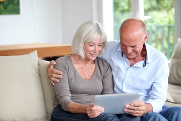 Senior couple researching on a tablet how to make a will and what is a Power of Attorney