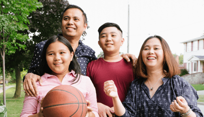 family of four immigrants smiling