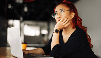 woman wearing glasses thinking