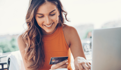 woman looking at credit card