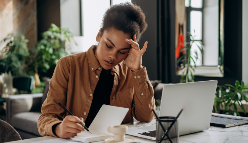 woman looking at her credit card bill worried