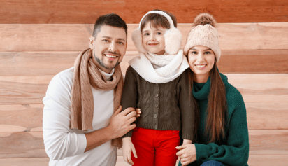 family wearing winter clothes and smiling