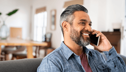 man smiling and talking on the phone