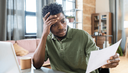 person stressed and looking at his taxes