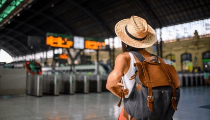 woman wearing a hat and backpack at the airport